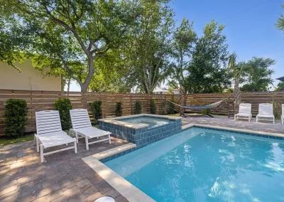 Black Pearl, pool & hot tub surrounded by lounge chairs