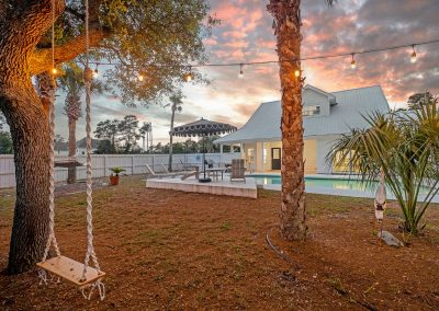 Palm Royale, backyard with pool and tree swing